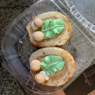 two cupcakes in a plastic container