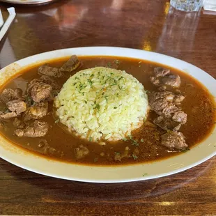 a plate of stew and rice