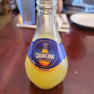 a bottle of orange juice on a table