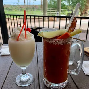 a bloody drink and a glass of milkshake