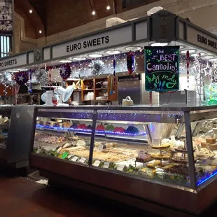 a deli counter with a variety of pastries