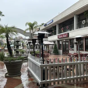 a patio area with tables and chairs