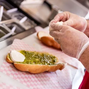 a person preparing a sandwich