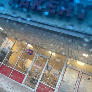 the front of a bakery in the rain