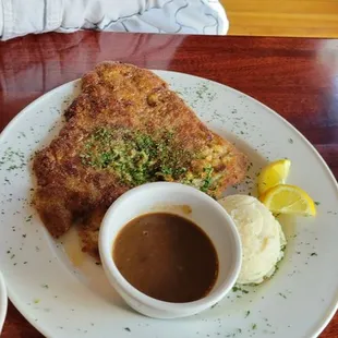 Pork Schnitzel with potatoes, house made gravy, and crazy tasty house made sauerkraut.