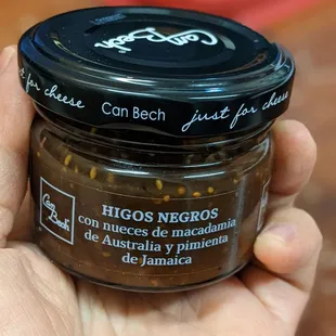 a hand holding a jar of food