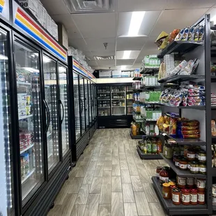 a grocery store aisle with refrigerators