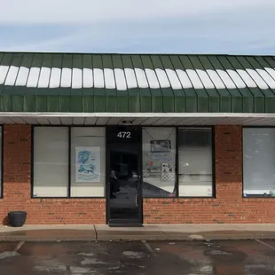 a brick building with a green roof