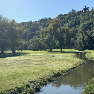 a golf course with a river running through it