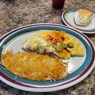 Farmer&apos;s omelet with added jalapenos and a biscuit.