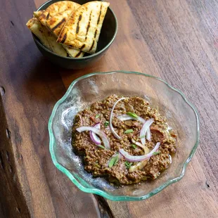 a bowl of food on a wooden table