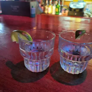 two shot glasses on a bar