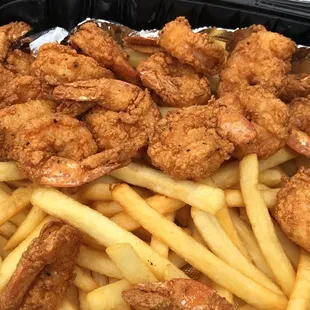a tray of fried shrimp and french fries