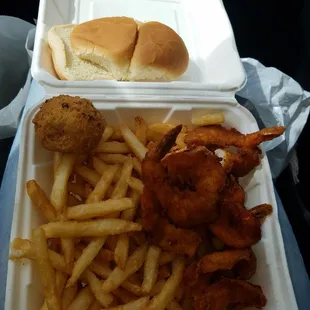 Fried shrimp, fries, and hush puppies