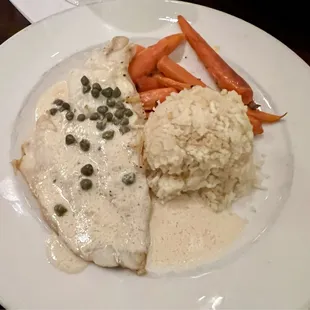 Lemon butter haddock with rice and carrots.