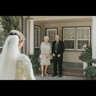 Near the greenery, behind the people is where the house the bridal room is in