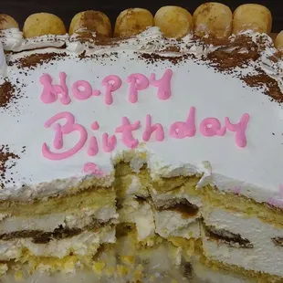 Huge tiramisu birthday cake with lady fingers around it. Half the cake was eaten when photo was taken $33 delicious as always!!
