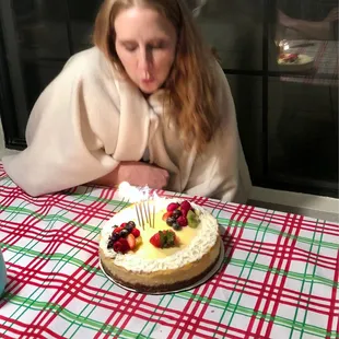 a woman blowing out candles