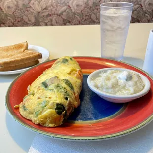 Veggie omelet, wheat toast, grits, water and coffee