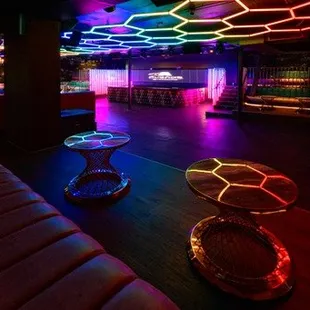 the interior of a nightclub with neon lights