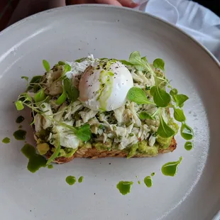 Avocado toast on multigrain bread topped with Dungeness crab and a poached egg (August 2018)