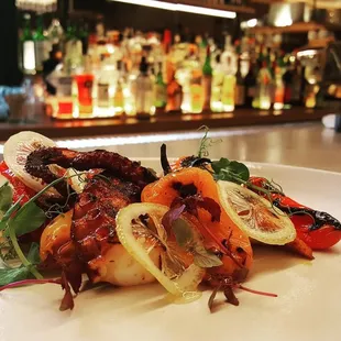 Charred octopus, dry fava bean purée, heirloom peppers, candied lemon