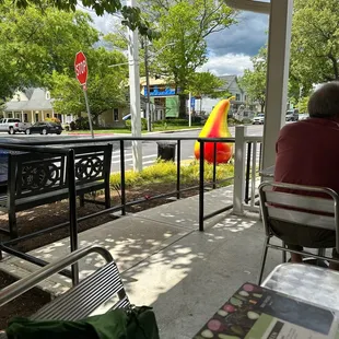 a man sitting at a table with an umbrella in the background