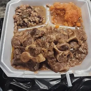 5 small oxtail over rice a scoop of yams and a scoop of blackeyed peas.