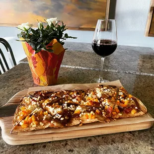 a pizza and a glass of wine