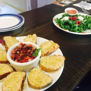 a plate of bread and a bowl of salad