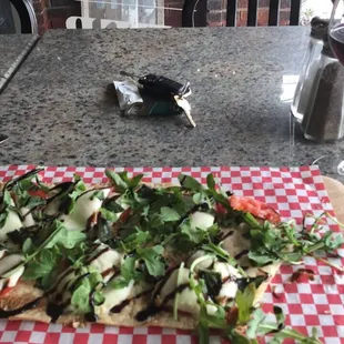 a flatbread pizza on a cutting board