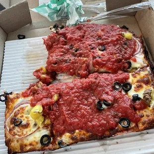 two slices of pizza in a box