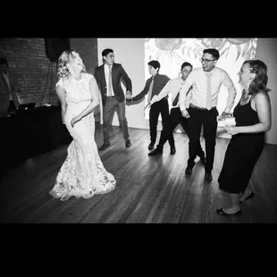 inside venue, gorgeous wood floors, projector, premium sound system, and beautiful brick walls with areas for tiny candles!