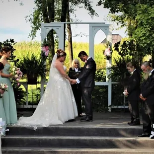 Prayers during ceremony in front of the BEAUTIFUL corn field and barn