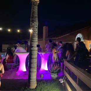 Beautiful LED Tables have a white spandex stretchy material and at night when you turn them on they can be any number of colors.