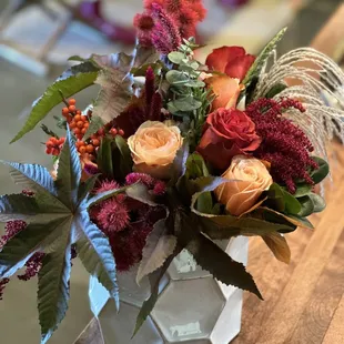 Rich castor foliage pops against the creamy hexagonal vessel