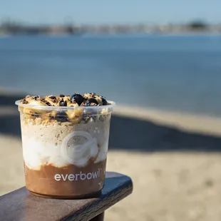 a cup of coffee on a bench