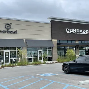 a black car parked in front of a store