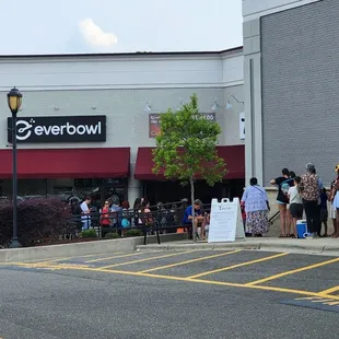 a crowd of people standing in a parking lot