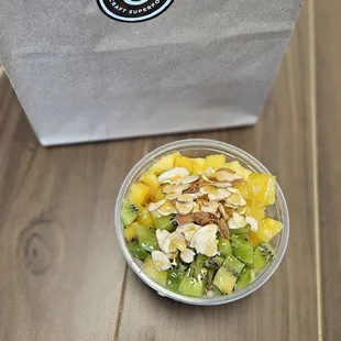 a bowl of fruit and nuts on a table