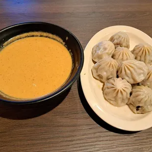 steamed lamb momos served with jhol