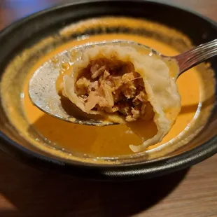 Inside a steamed lamb momo served with jhol