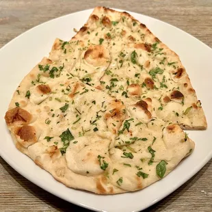 Garlic Naan. Soft, thin naan bread with garlic flavors. Perfect for dipping into the Saag Paneer.