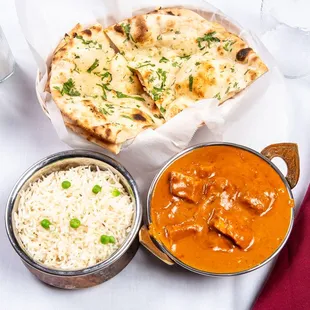 Chicken tikka masala with rice and garlic cilantro naan on the side