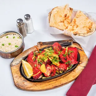 Tandoori chicken with rice and naan on the side