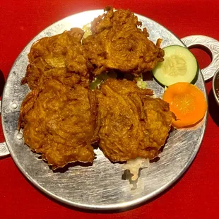 Onion Bhaji- Onion, potato, and spinach fritters fried in gram flour batter.