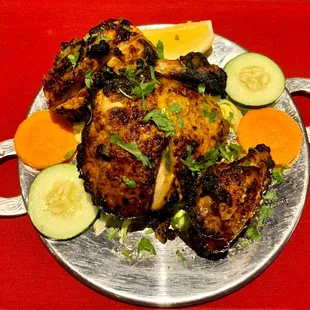 Tandoori Chicken - Marinated in yogurt, garlic, and herbs to produce a crispy on the outside and juicy on the inside tandoor delicacy.