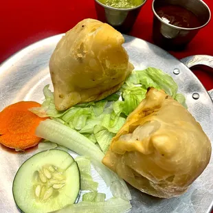 Vegetable Samosa - Fried crispy pastry stuffed with delicately spiced potatoes and peas.