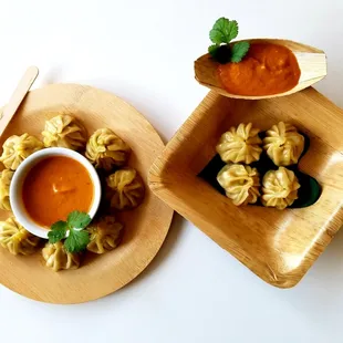 MoMos served in eco-friendly small ware, with House made sauce.