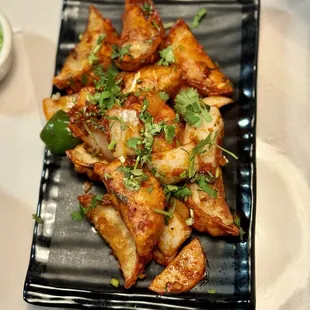 Chicken momo/dumplings in chilli sauce, has a bite to it!